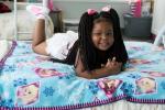 Child laying on bed